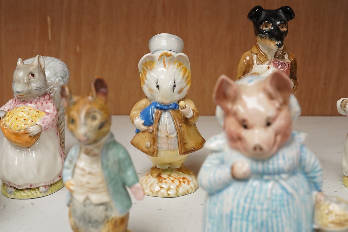A collection of thirteen Beatrix Potter character figures, stamped with a gold stamp F Warn and Co Ltd, Beswick England, largest 12cm high